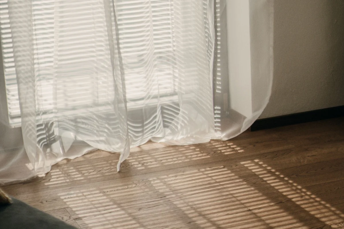 Curtains ending above a wooden floor
