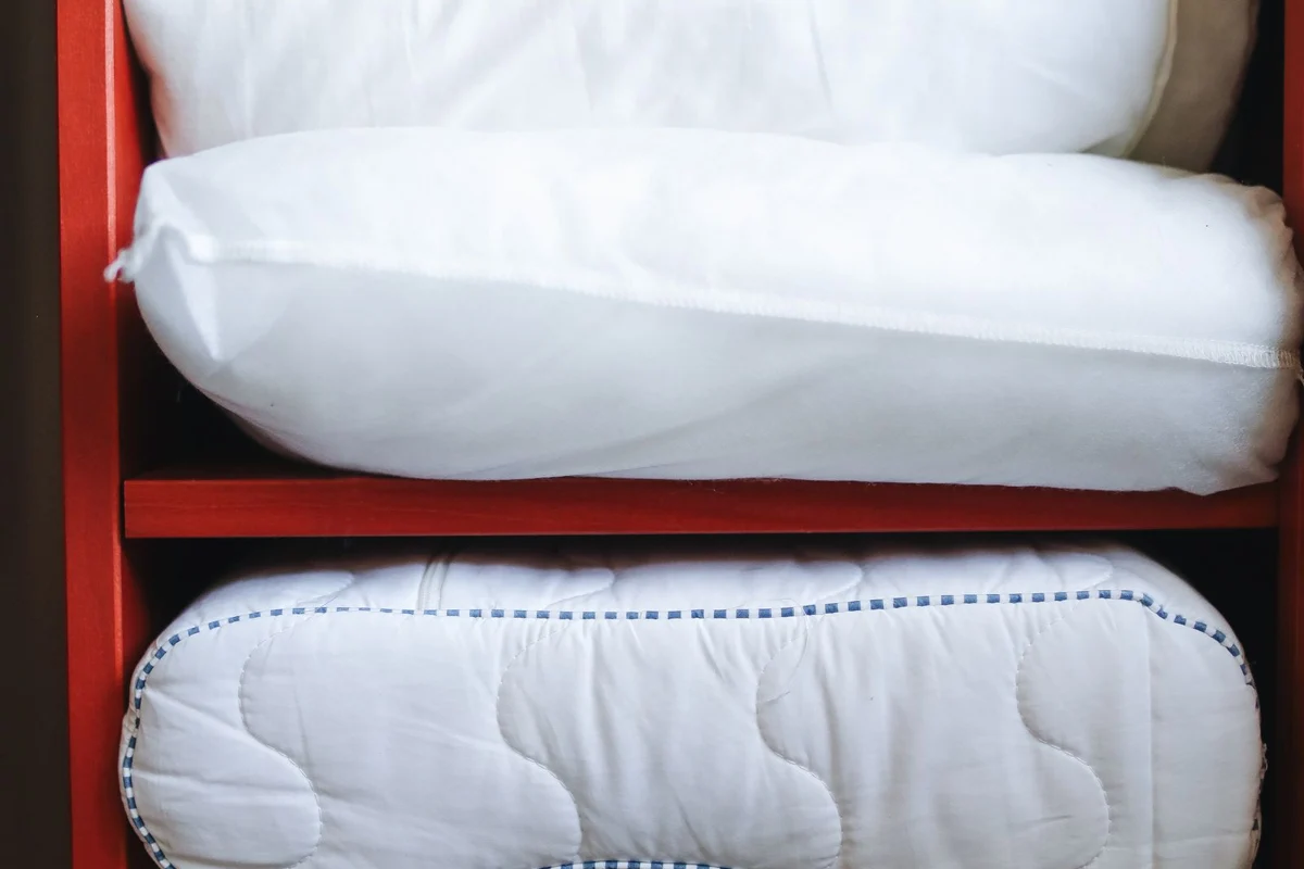 Bedding arranged on a storage shelf