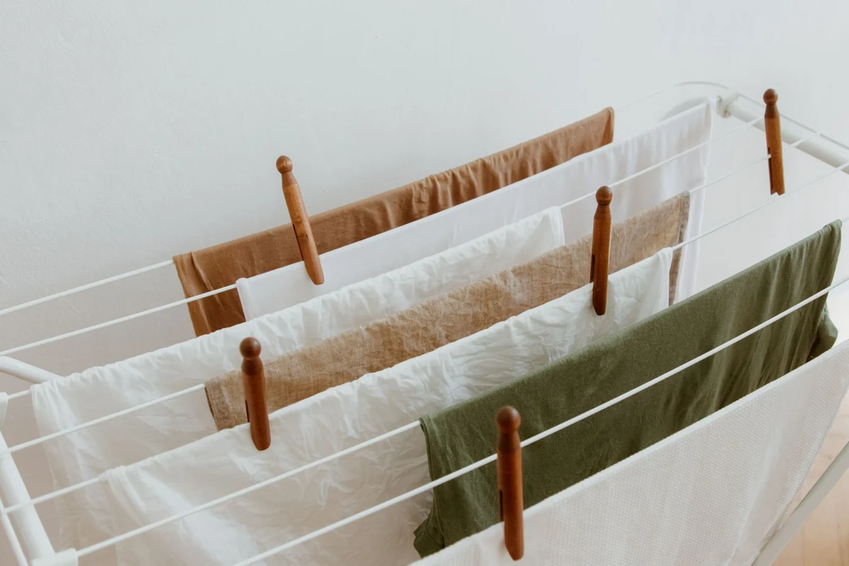 Laundry spaced along an indoor drying rack