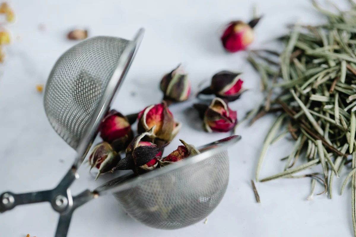 Herbal tea leaves in a metal strainer