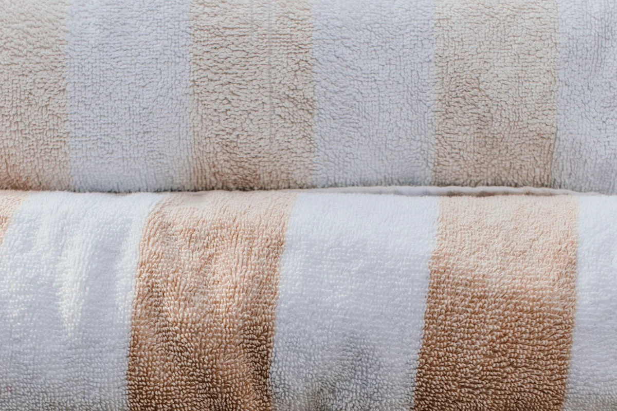 Folded towels on a woven basket