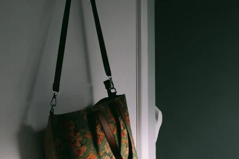 A fabric bag hanging from a door hook