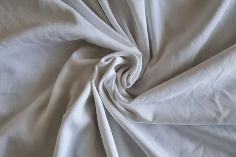 Cotton bedsheet fabric gathered into folds