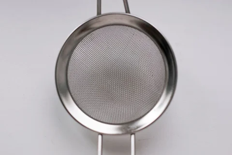 Close view of a metal mesh kitchen sieve