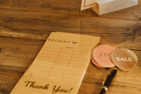A receipt and tags on a wooden table