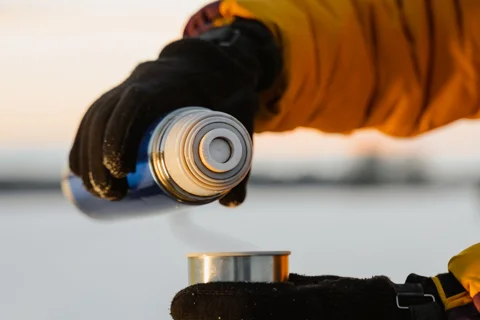 A hot drink poured from an insulated flask