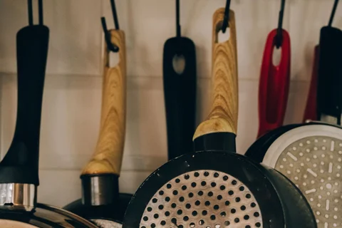 Cooking pans hanging by their different handles