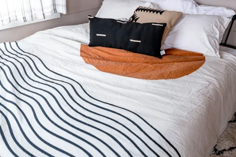 Pillows in their cases on a made bed