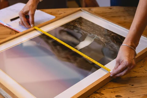 A tape measure checking the dimensions of a frame