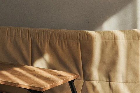 A patterned throw draped over a sofa