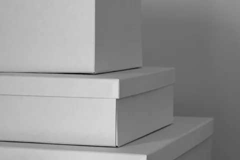 Three lidded storage boxes stacked together