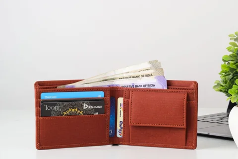 An open wallet with Indian currency and cards